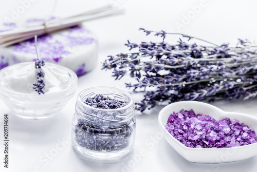 organic cosmetic with lavender flowers and bath salt on white ba