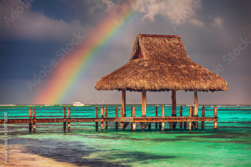 Fototapeta Naklejka Na Ścianę i Meble -  Rainbow over the Tropical beach in Punta Cana, Dominican Republic