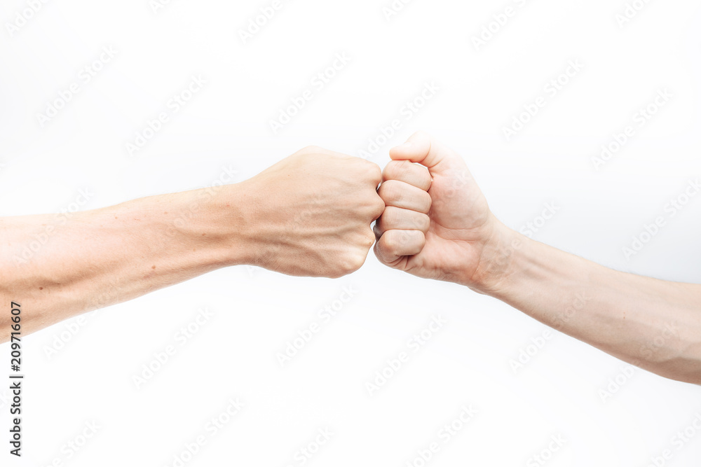 Close-up of the hand, makes a fist kick on a white background. Business people make a Cam pump together after a good deal. The concept of business success and teamwork.for advertisement Close-up of the hand, makes a fist kick on a white background. Business people make a Cam pump together after a good deal. The concept of business success and teamwork.for advertisement