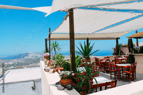 Aegean sea and restaurant at Pyrgos town in Santorini island, Greece