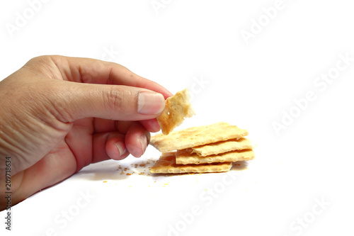 healthy adult hand hold a cracker on white background isolated