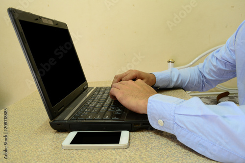 a man use laptop computer  in a bedroom 