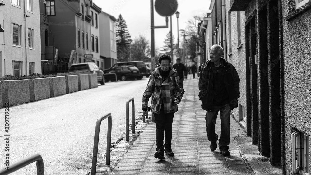 Asian senior couple walking in Rekjavik, Iceland black and white