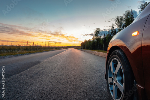 Cars on the road. Sunset in the countryside