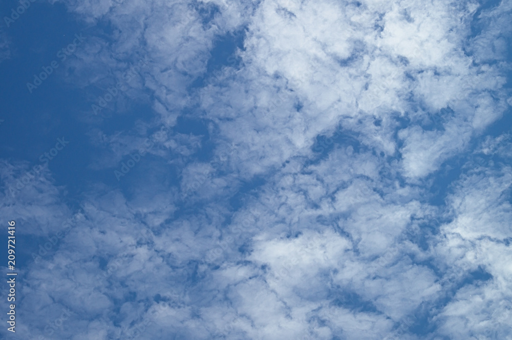 A blue day sky with rare beautiful clouds for the designer's background A blue day sky with rare beautiful clouds for the designer's background