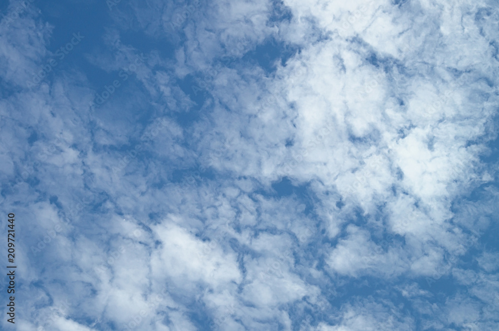 A blue day sky with rare beautiful clouds for the designer's background A blue day sky with rare beautiful clouds for the designer's background