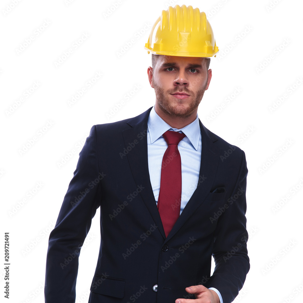 portrait of serious businessman with construction helmet on head portrait of serious businessman with construction helmet on head