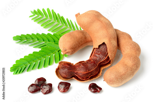 fresh tamarind fruits and leaves isolated on white background photo