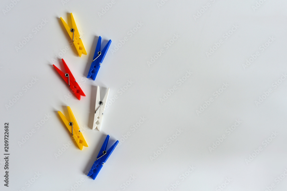 Multi-colored clothespins on a white background. Funny colored clothespins. Designer background Multi-colored clothespins on a white background. Funny colored clothespins. Designer background