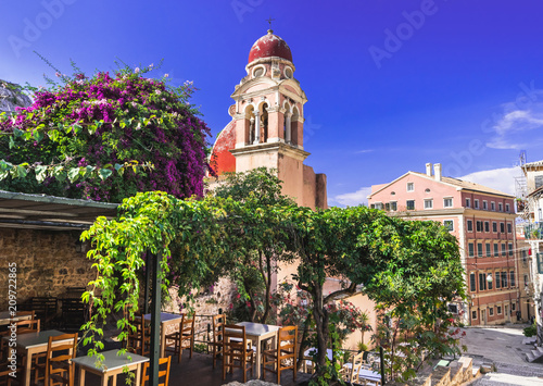 Corfu town picturesque street with cafe and flowers, Corfu island, Ionian islands, Greece