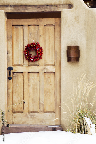 Wreath Red Chile Ristra Hanging on Wooden Door, Santa Fe, New Mexico
