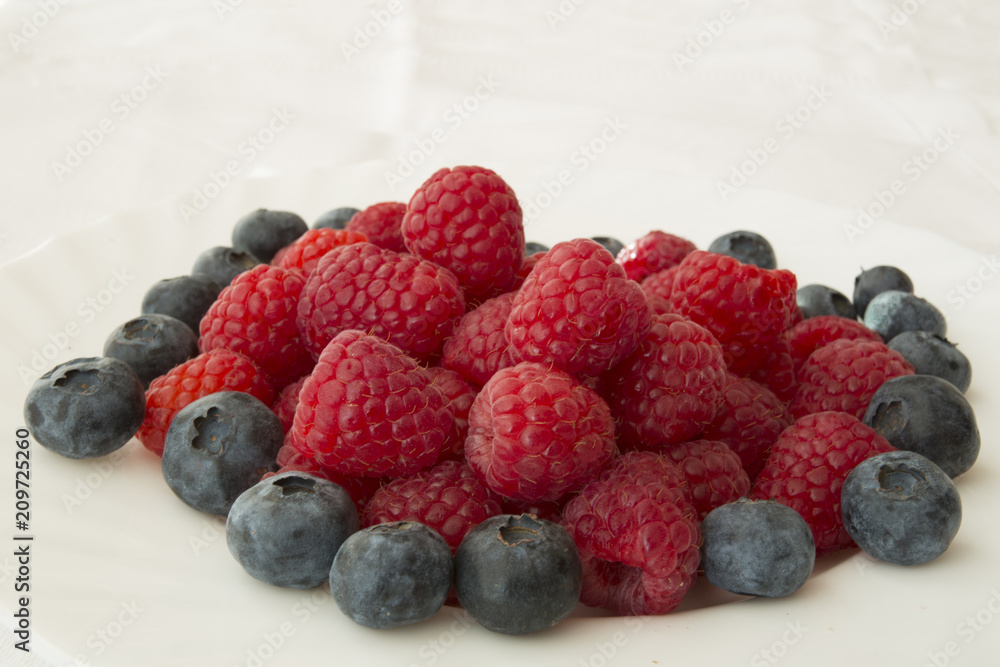 raspberry and blueberries on white background raspberry and blueberries on white background