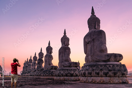 Big buddha stature with photographer and color of sky © jimbophotoart