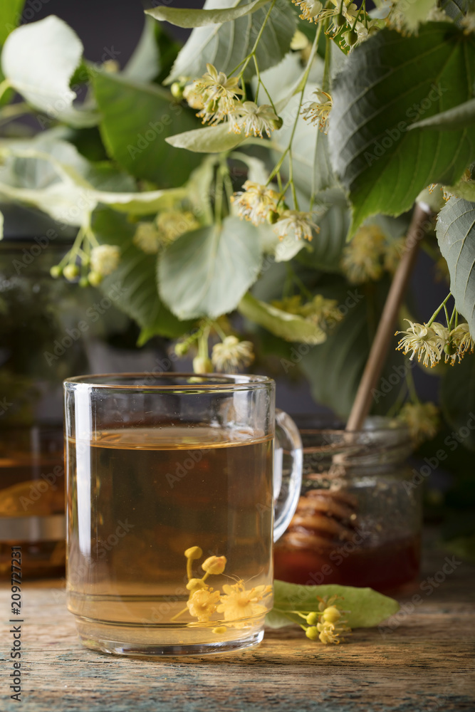 Glass of linden tea with honey on wooden table. Glass of linden tea with honey on wooden table.