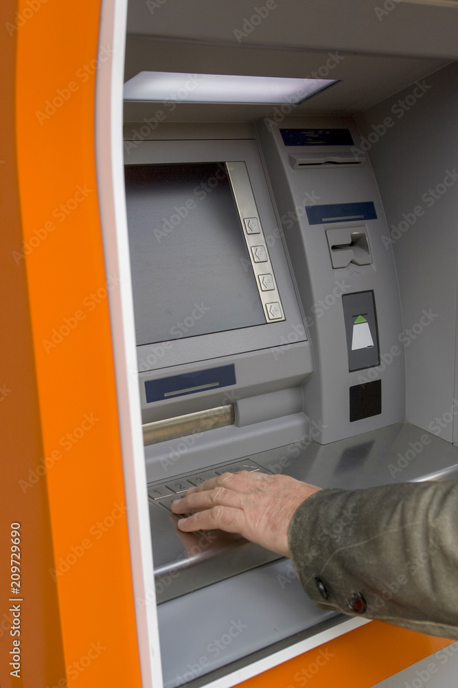Male hand at European ATM Male hand at European ATM