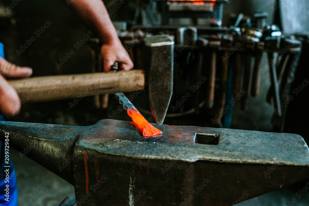 Close-up image of blacksmith at work in the smithy.