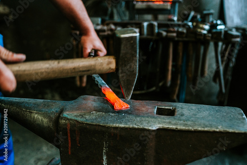 Close-up image of blacksmith at work in the smithy.