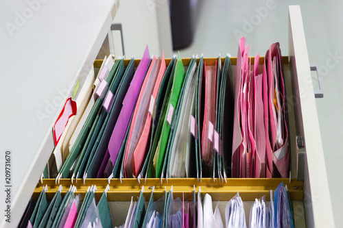 Files document of hanging file folders in a drawer in a whole pile of full papers, at work office Bangkok Thailand Business Concept 