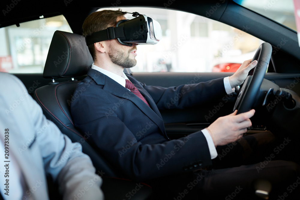 Side view portrait of handsome businessman wearing VR headset driving luxury car, modern technology concept