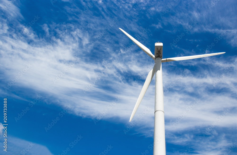 wind generator of electricity from three blades against the background of clouds and blue sky wind generator of electricity from three blades against the background of clouds and blue sky