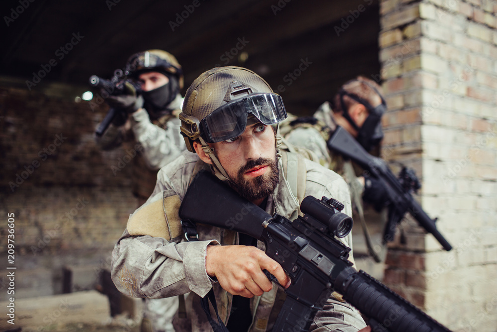 Foto de A picture of warriors standing outside. THey are holding rifles ...