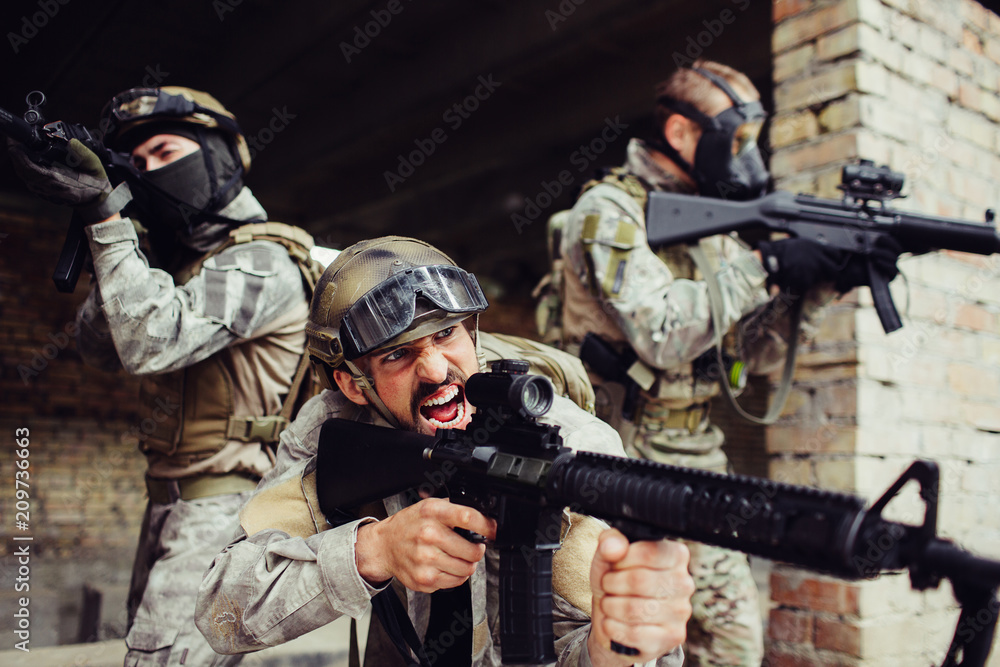 Emotional front man is standing outside with his soldiers and screaming. All of them have black rifles. They are dangerous. Guys are ready to fight. Emotional front man is standing outside with his soldiers and screaming. All of them have black rifles. They are dangerous. Guys are ready to fight.
