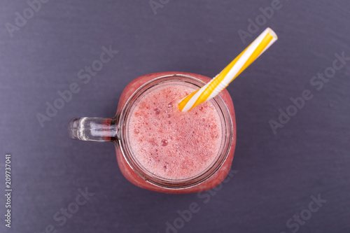 Healthy eating, food, dieting and vegetarian concept - glass of smoothies from strawberries, raspberries and banana, close up