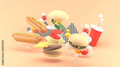 Hamburgers, hot dogs and soft drinks among colorful balls on an orange background.-3d rendering.