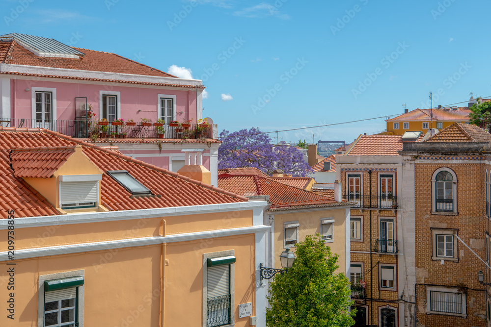 Colorful buildings with red tile roofs in the Alfama district of Lisbon, Portugal