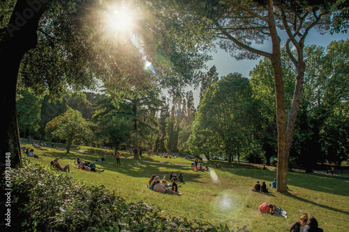 View of people in park of the Villa Borghese on a sunny day in Rome, the incredible city of the Ancient Era, known as 