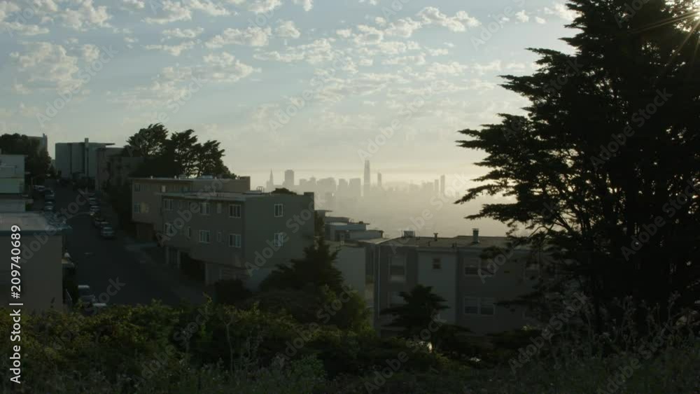 San Fransisco skyline through neighborhood houses San Fransisco skyline through neighborhood houses