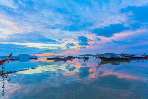sweet sunrise above fishing boats in Rawai sea during high tide