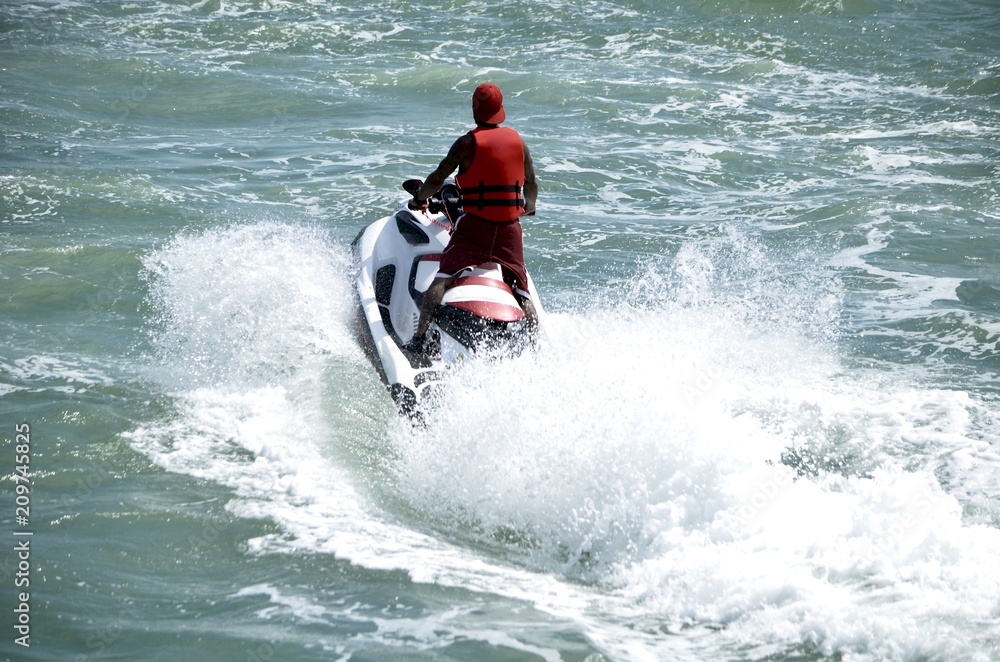 Jet skier running waves on the florida intra-coastal waterway offMiami Beach.