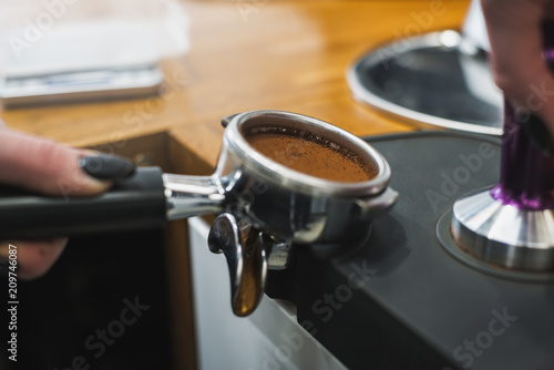 Barista tamping coffee