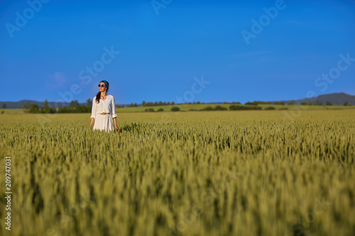 Beautiful girl in white shirt standing in the field © Володимир Кудляк