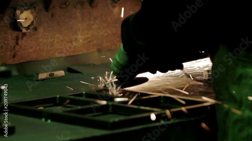 Workers grinding metal chair in factory photo