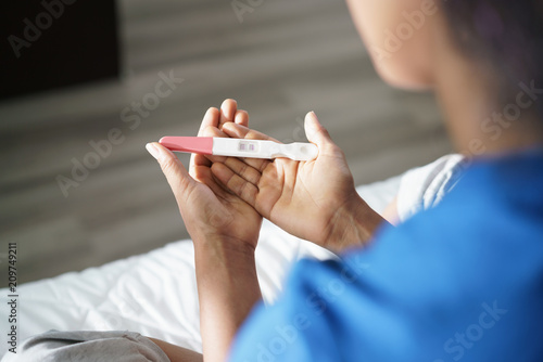 Woman Holding Positive Pregnancy Test Kit