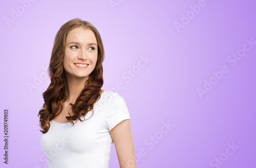 body positive and people concept - happy woman in white t-shirt over ultra violet background