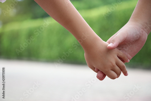 Hands of brother and sister children hands holding together take care and support parent concept