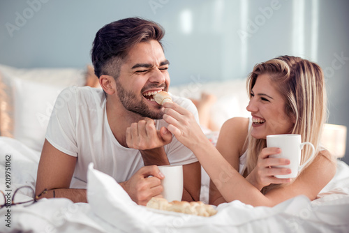 Young couple having a breakfast in the bed