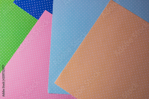 Multi colored abstract paper of pastel colors; with geometric shape; flat lay, minimalism style.