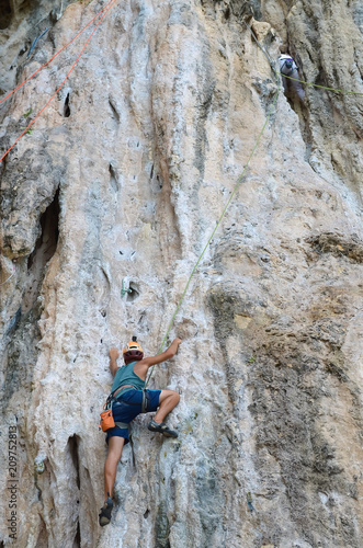 Man climbing the cliff in Railey, Thailand