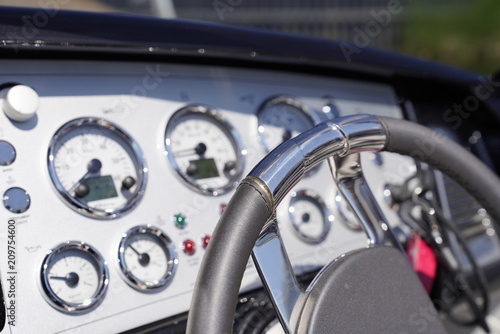 Steering wheel and a cockpit of a luxury motorboat © Eduards