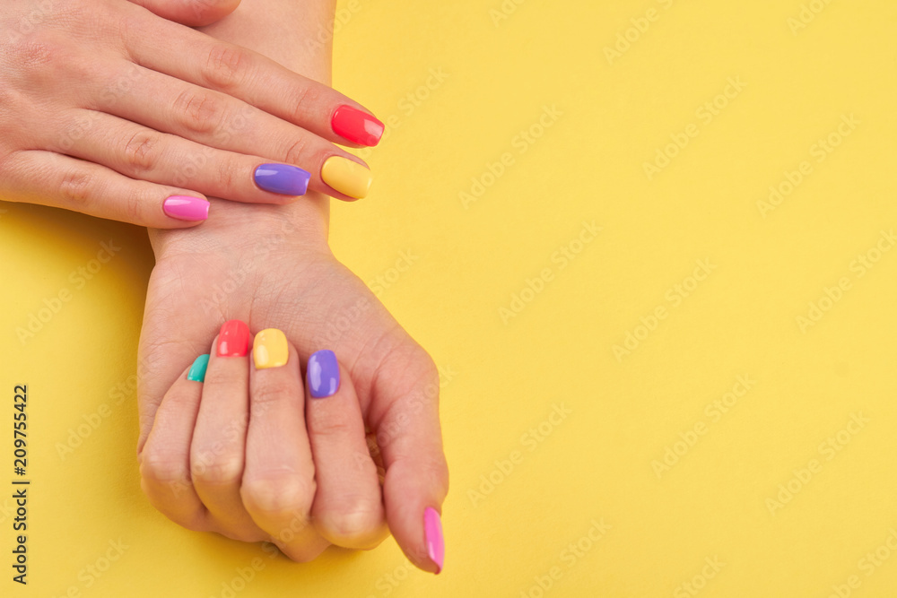 Female pastel manicure, yellow background. woman hands with beautiful colorful summer nails, copy space. Salon beauty and spa. Female pastel manicure, yellow background. woman hands with beautiful colorful summer nails, copy space. Salon beauty and spa.
