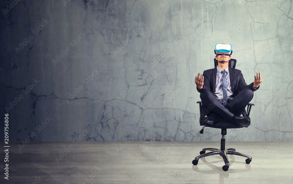 Businessman sitting in chair wearing virtual reality glasses. Empty space for text or draw Businessman sitting in chair wearing virtual reality glasses. Empty space for text or draw
