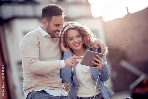 Couple listening to music on tablet