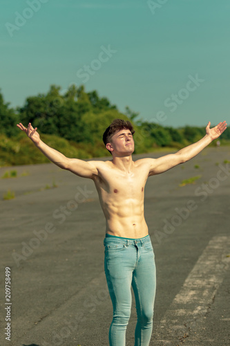 Young adult male shirtless outdoors