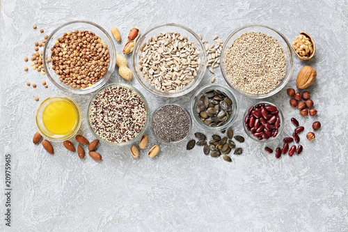 Super food dried ingredients group included quinoa, chia seeds, sesame, lentils, sunflofer and pumpkin seeds, red beans and nuts. Healthy, vegetarian and clean eating concept. Overhead view,copy space