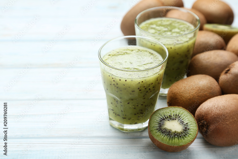 Fresh kiwi smoothie in glass on wooden table Fresh kiwi smoothie in glass on wooden table