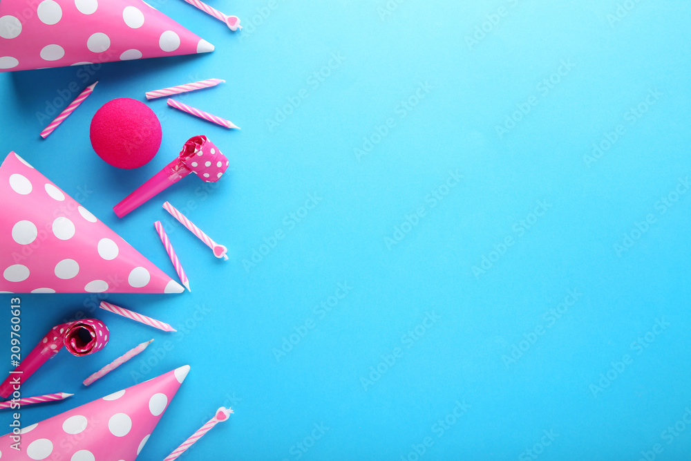 Obraz premium Birthday party caps, blowers and candles on blue background